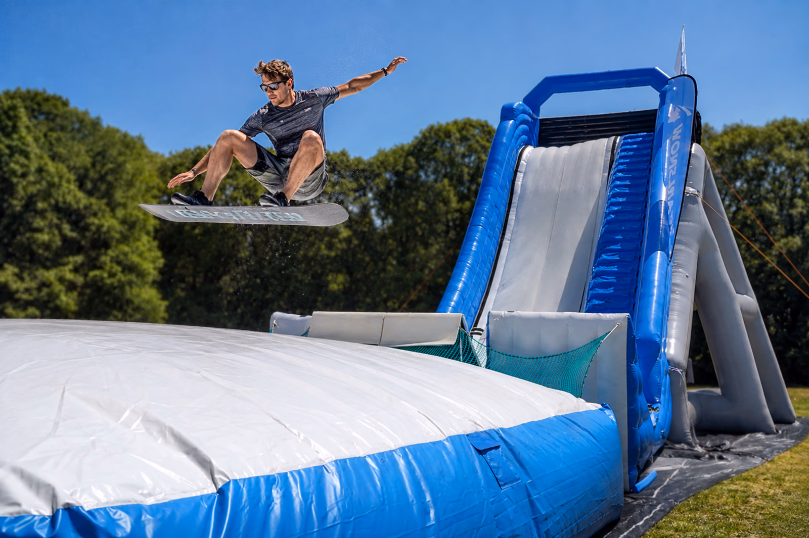 Snowboarder performing a nose grab on Pearljump